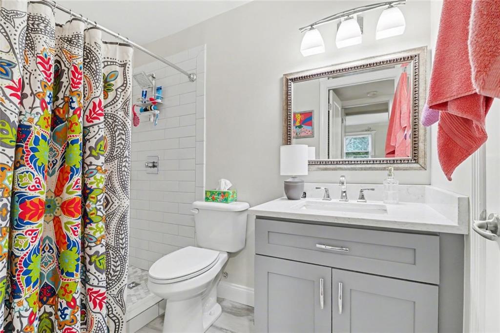 3650 Ashford Dunwoody Road Northeast, Unit 904 Atlanta, GA 30319 - Photo 19 of 33 a bathroom with a sink toilet and a mirror