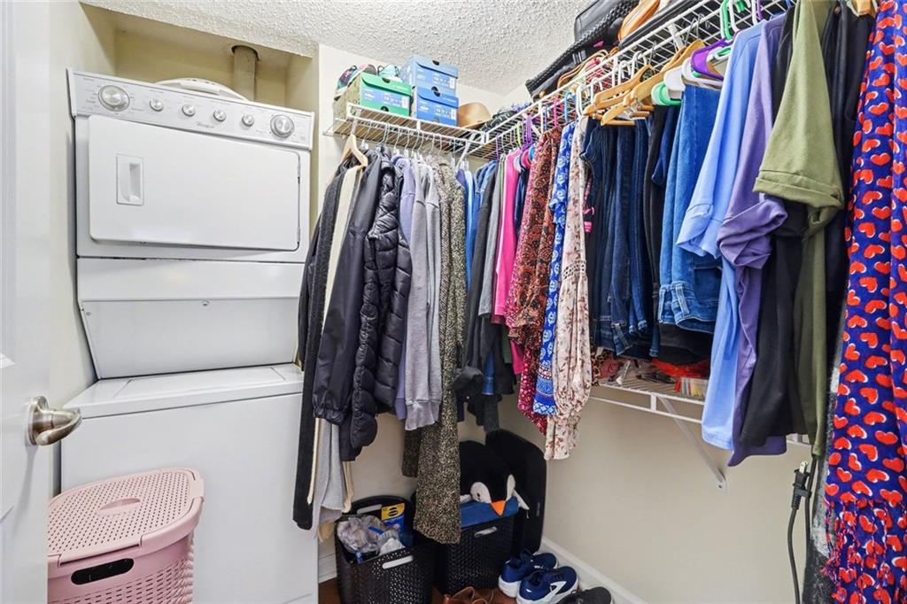 3650 Ashford Dunwoody Road Northeast, Unit 904 Atlanta, GA 30319 - Photo 21 of 33 a view of walk in closet with clothes and shoes