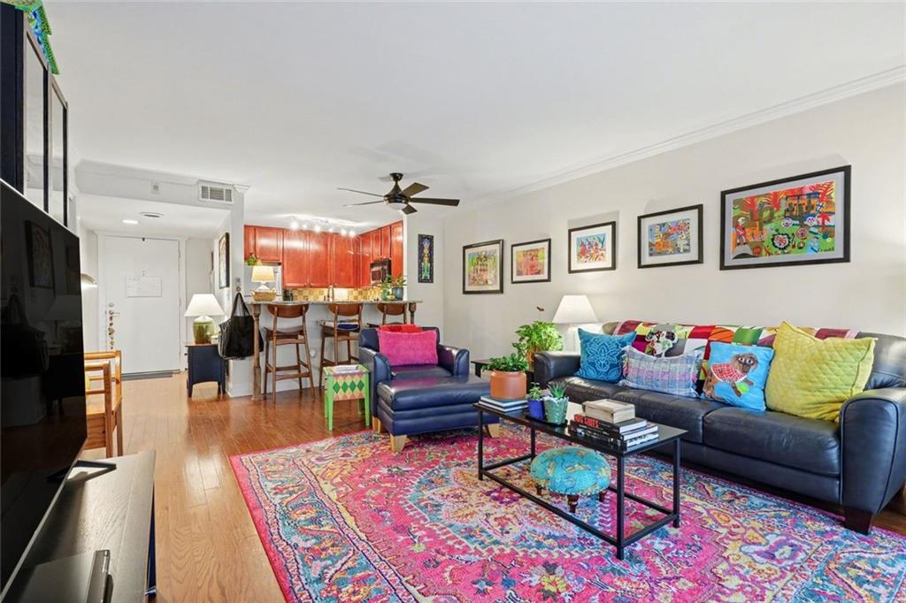 3650 Ashford Dunwoody Road Northeast, Unit 904 Atlanta, GA 30319 - Photo 10 of 33 a living room with furniture and wooden floor