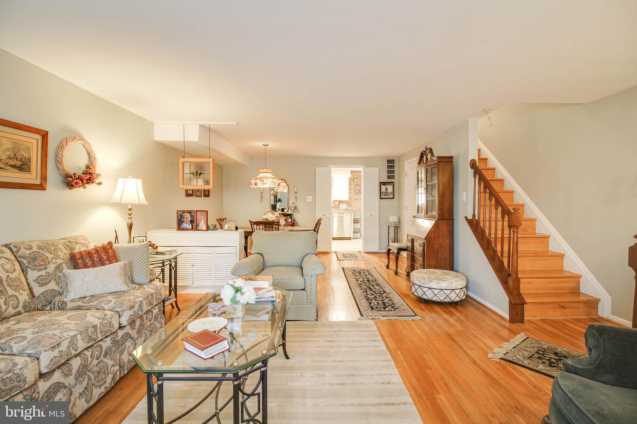 5649 Chelwynd Road Halethorpe, MD 21227 - Photo 2 of 44 a living room with furniture and a dining table with wooden floor