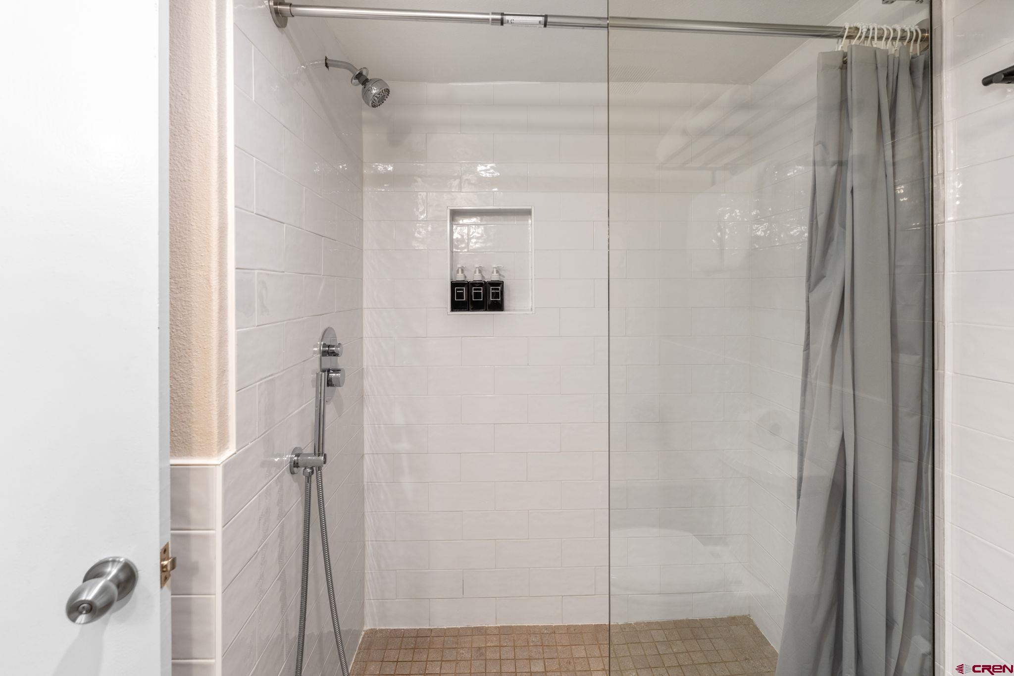72 Hunter Hill Road, Unit I204 Crested Butte, CO 81225 - Photo 31 of 44 a bathroom with a glass shower door