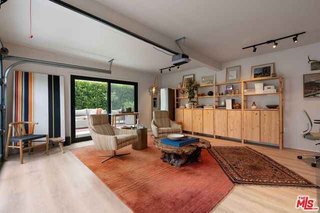 a living room with furniture gym equipment and a large window