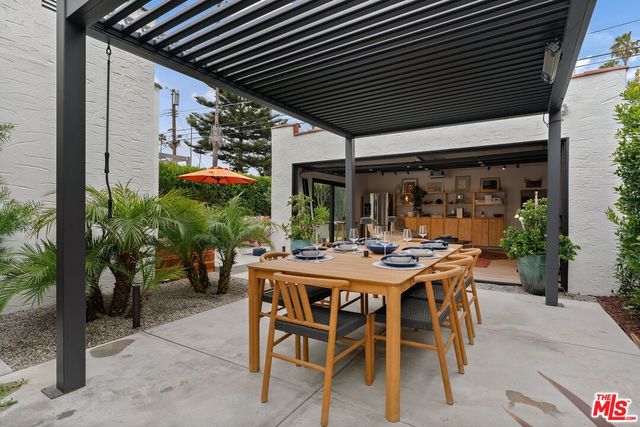 a view of an outdoor dining space with a table and chairs