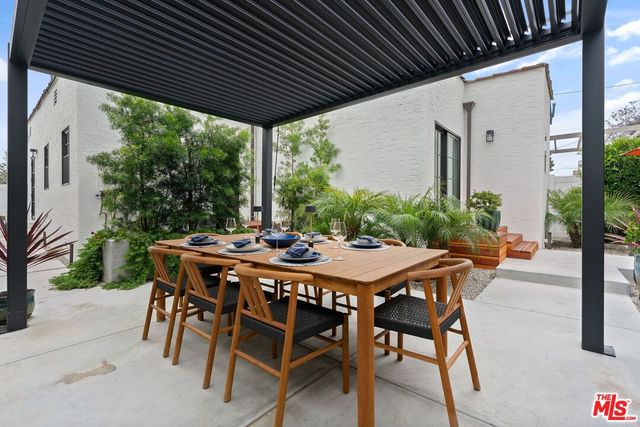 a outdoor living space with furniture and umbrella