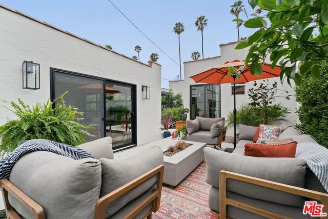 a view of a house with backyard and sitting area