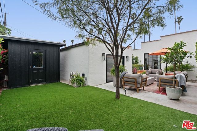 a house view with a seating space and garden