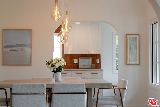 a view of a dining room with furniture and a potted plant