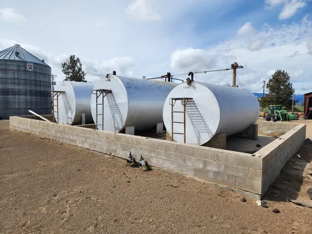 a view of a terrace with a table and chairs under an umbrella
