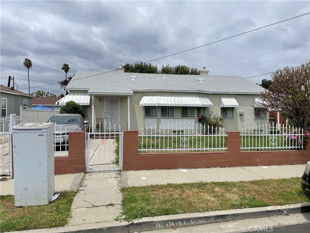 1137 West Spruce Street Compton, CA 90220 - Photo 1 of 1 a front view of a house with a garden and plants