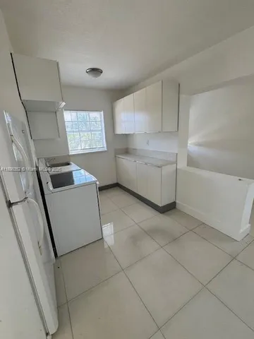 a kitchen with a sink and a stove top oven