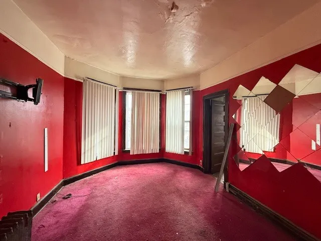 a view of an empty room with windows