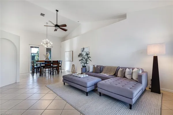 a living room with furniture and a chandelier