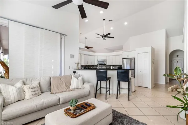 a living room with furniture and kitchen view