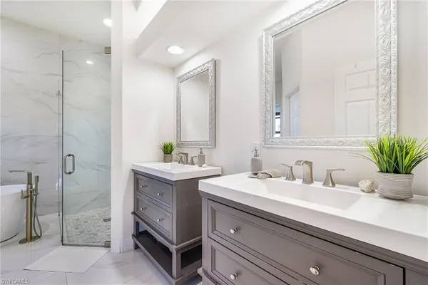 a bathroom with a sink double vanity and a mirror