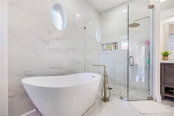 a bathroom with a bathtub and a shower