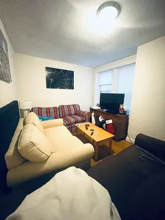 a living room with furniture and a lamp
