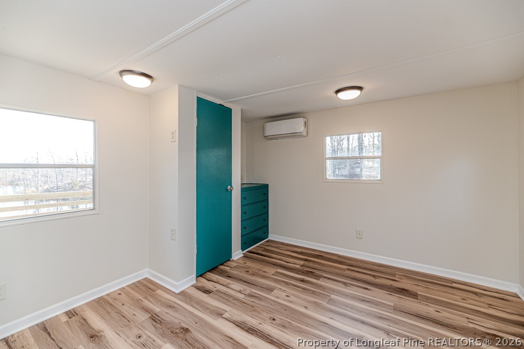 161 White Oak Street Carthage, NC 28327 - Photo 16 of 29 a view of a bedroom with wooden floor and window