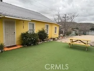 a view of swimming pool with outdoor seating and house in the background