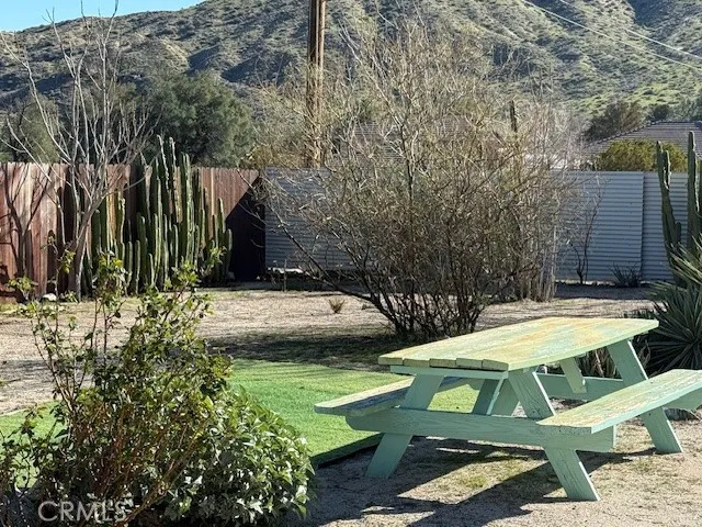 a view of backyard with swimming pool and seating space