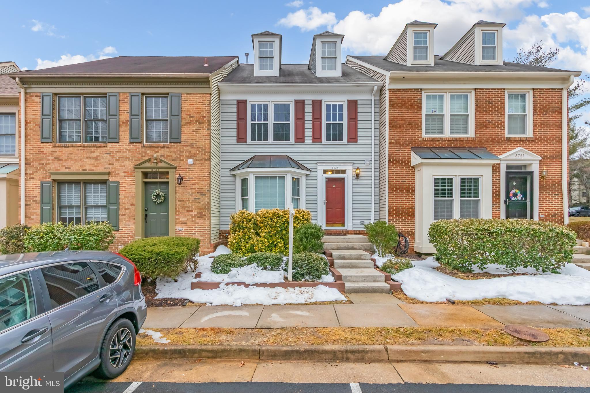 8735 Stone Hill Place Springfield, VA 22153 - Photo 1 of 51 a front view of a residential apartment building with a yard