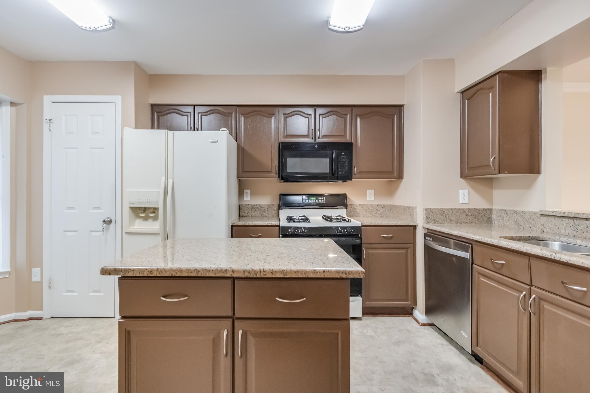 8735 Stone Hill Place Springfield, VA 22153 - Photo 13 of 51 a kitchen with a refrigerator sink and stove