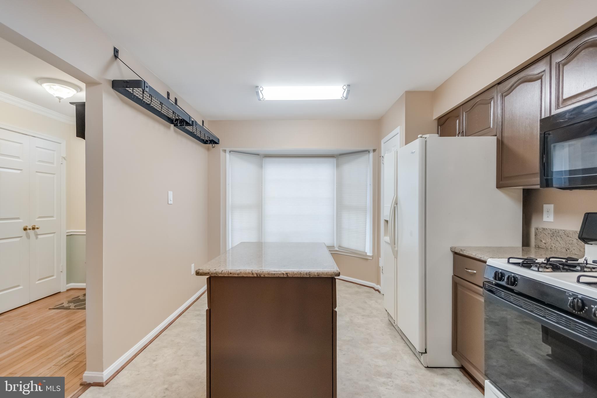 8735 Stone Hill Place Springfield, VA 22153 - Photo 15 of 51 a kitchen with stainless steel appliances granite countertop a refrigerator and a stove
