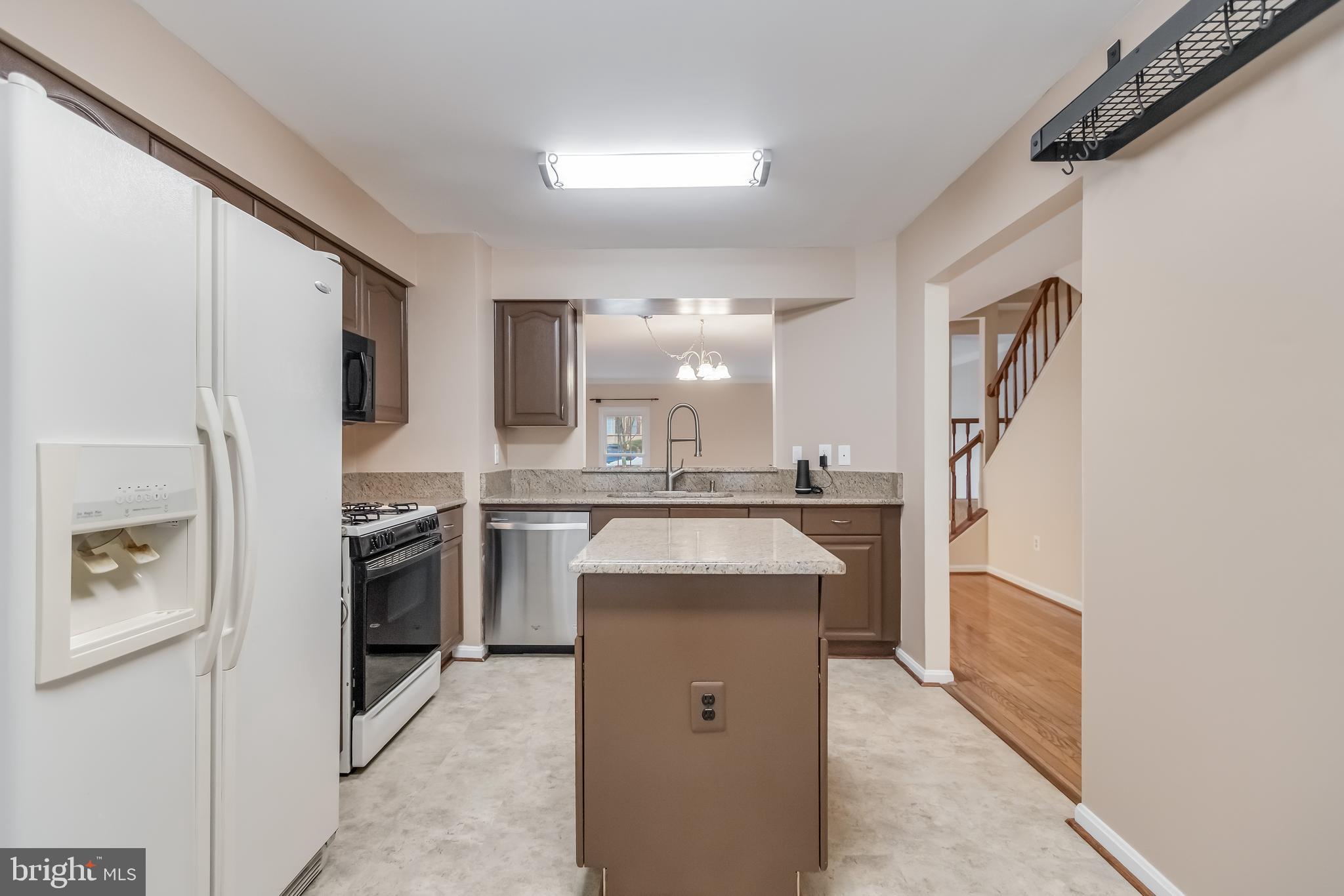 8735 Stone Hill Place Springfield, VA 22153 - Photo 16 of 51 a kitchen with a refrigerator stove and sink