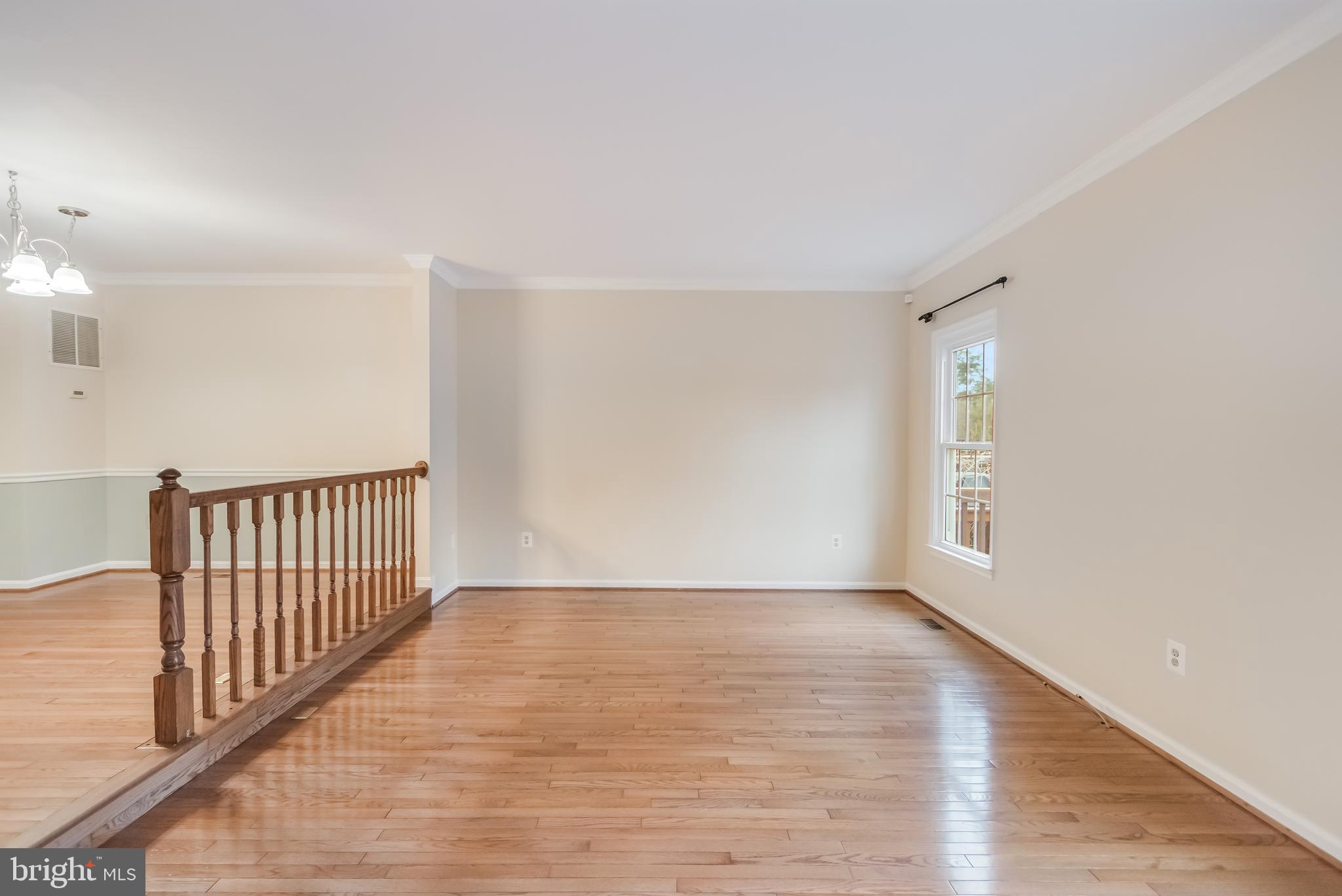 8735 Stone Hill Place Springfield, VA 22153 - Photo 24 of 51 a view of an empty room with wooden floor and a window