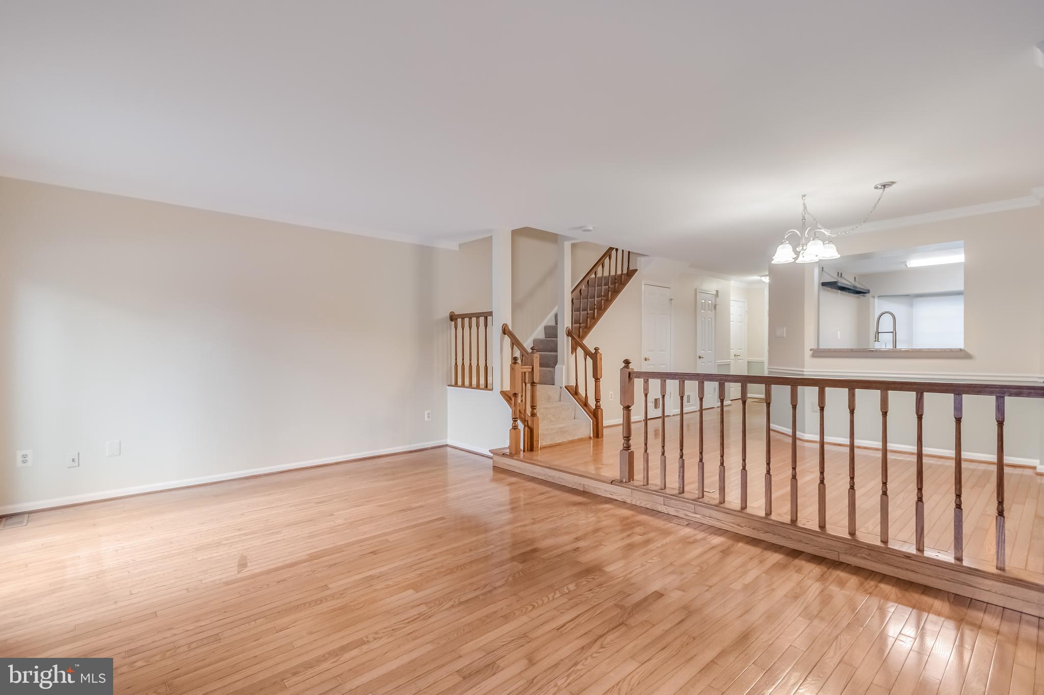 8735 Stone Hill Place Springfield, VA 22153 - Photo 25 of 51 a view of a hallway with wooden floor