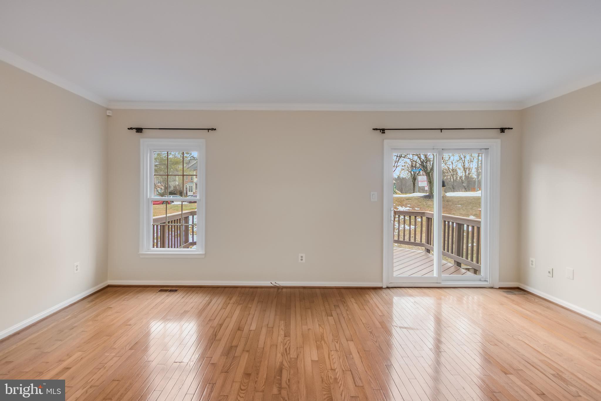 8735 Stone Hill Place Springfield, VA 22153 - Photo 26 of 51 an empty room with wooden floor and windows
