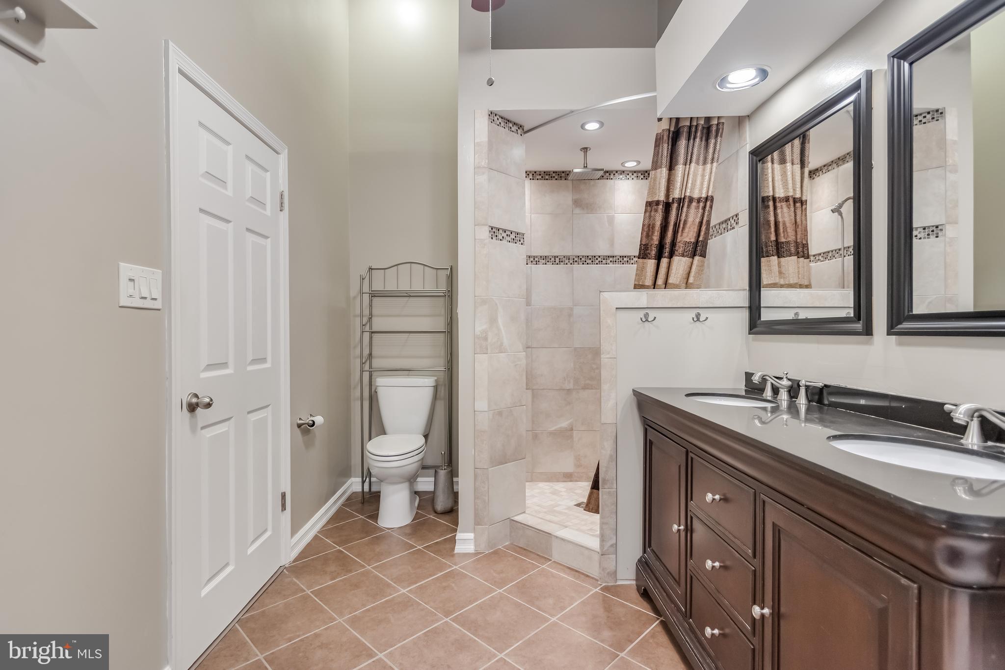 8735 Stone Hill Place Springfield, VA 22153 - Photo 32 of 51 a spacious bathroom with a granite countertop sink mirror and a toilet