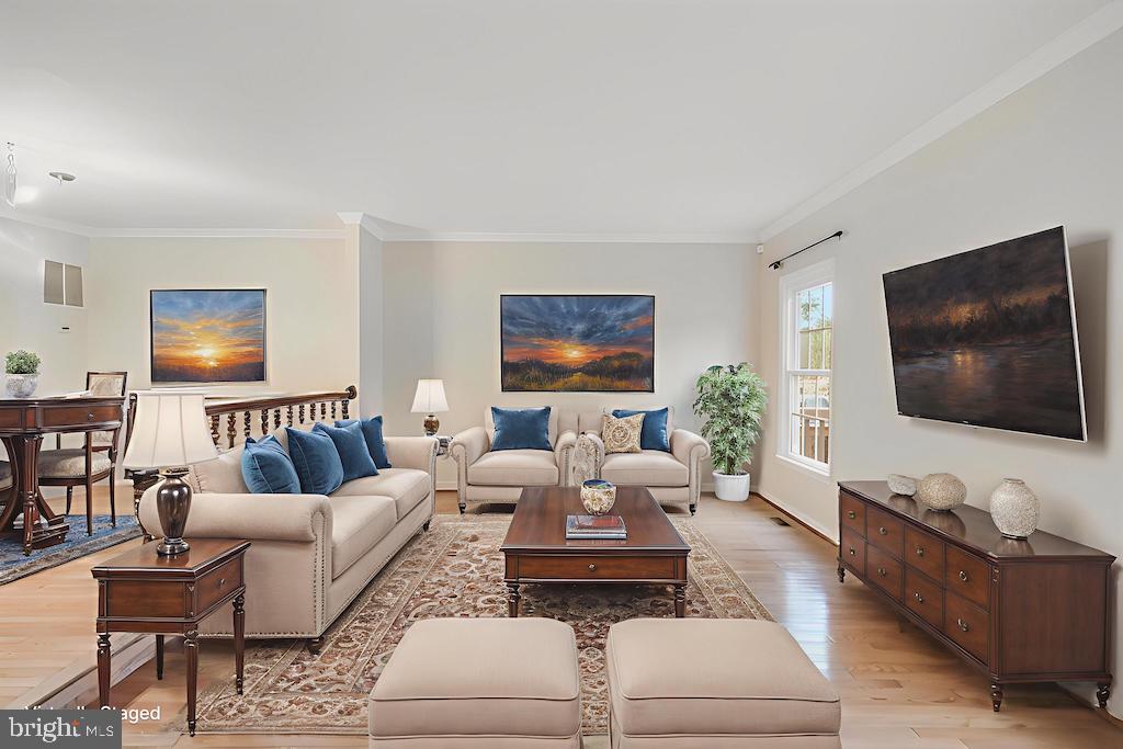 8735 Stone Hill Place Springfield, VA 22153 - Photo 4 of 51 a living room with furniture and a flat screen tv