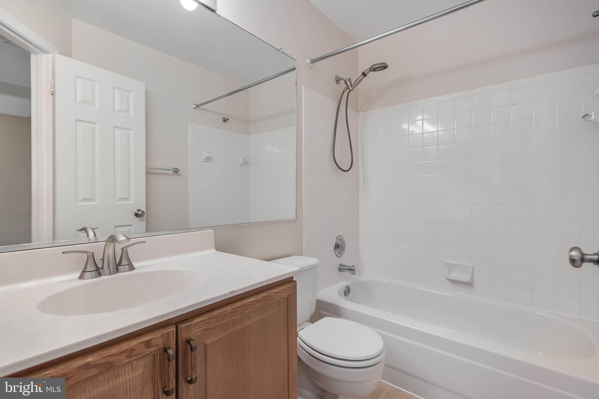 8735 Stone Hill Place Springfield, VA 22153 - Photo 42 of 51 a bathroom with a sink toilet vanity and shower