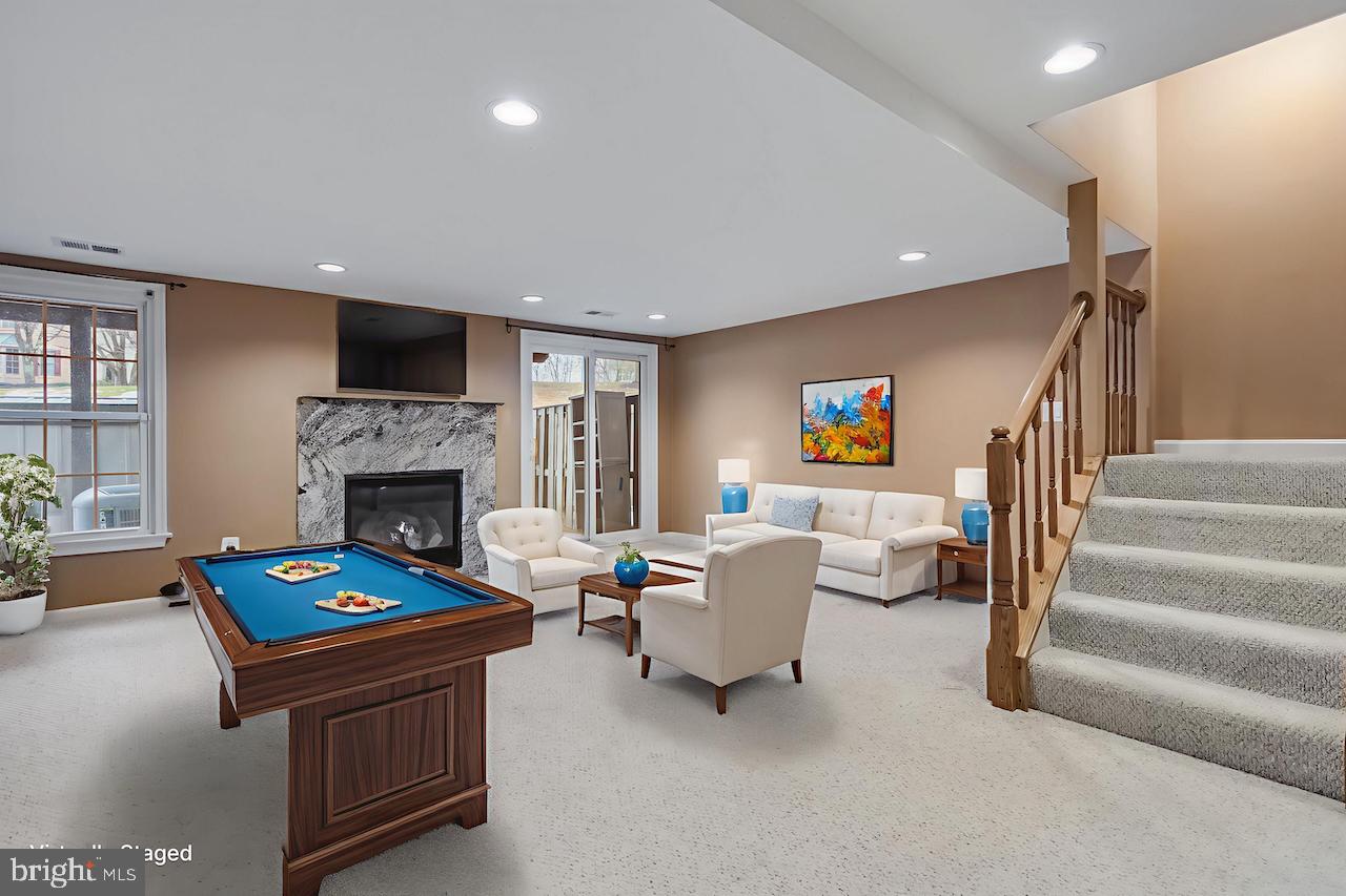 8735 Stone Hill Place Springfield, VA 22153 - Photo 5 of 51 a living room with furniture and a fireplace