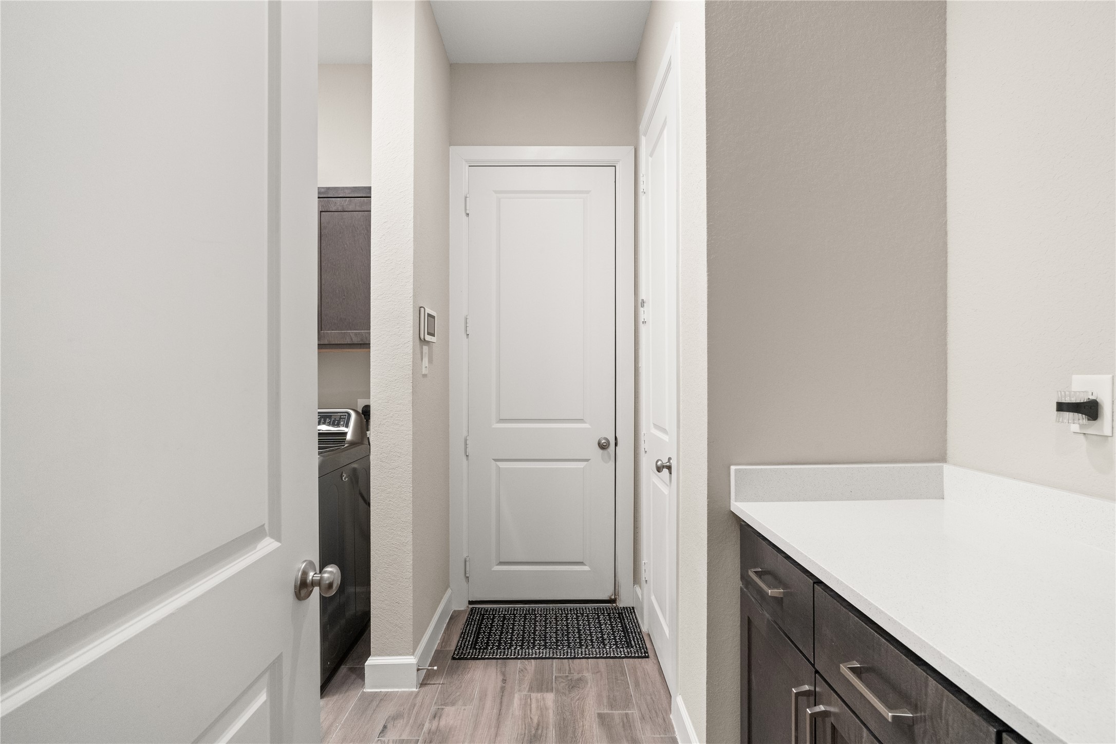 3118 Swift Way Katy, TX 77493 - Photo 23 of 34 Utility Room / Mudroom Entry – A practical utility space with built-in cabinetry and counter space, providing convenience for laundry and everyday organization.