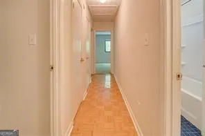 a view of a hallway with wooden floor