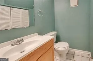 a bathroom with a sink a toilet and a window