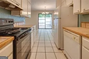 a view of an empty room with a chandelier