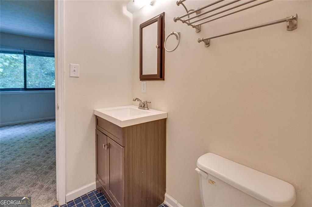 3782 Mulkey Circle Southwest, Unit 18 Austell, GA 30106 - Photo 35 of 54 a bathroom with a toilet sink and mirror