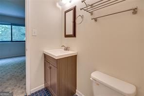 3782 Mulkey Circle Southwest, Unit 18 Austell, GA 30106 - Photo 8 of 54 a bathroom with a toilet sink and mirror