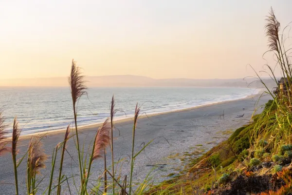 a living room with furniture and floor to ceiling windows