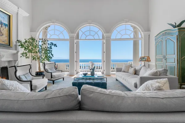 a view of a dining room with furniture chandelier and a chandelier