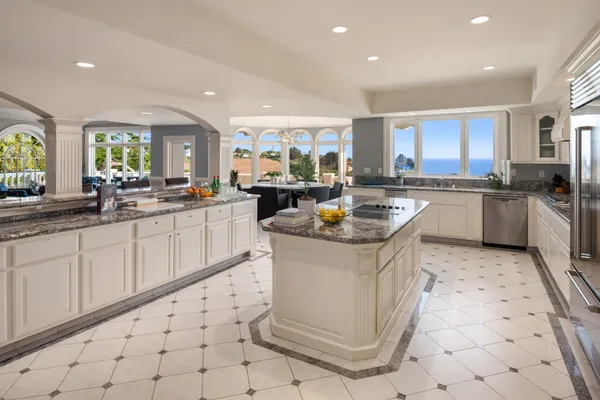 a dining room with furniture and a floor to ceiling window