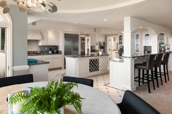 a living room with furniture and a large window with garden view