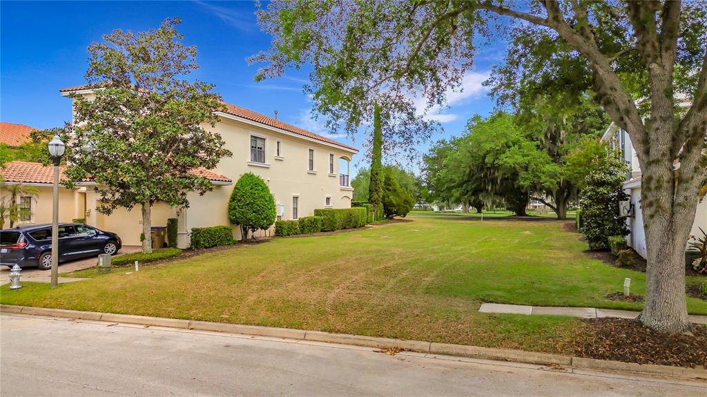 1233 Radiant Street Reunion, FL 34747 - Photo 2 of 18 a view of a house with a yard and tree s