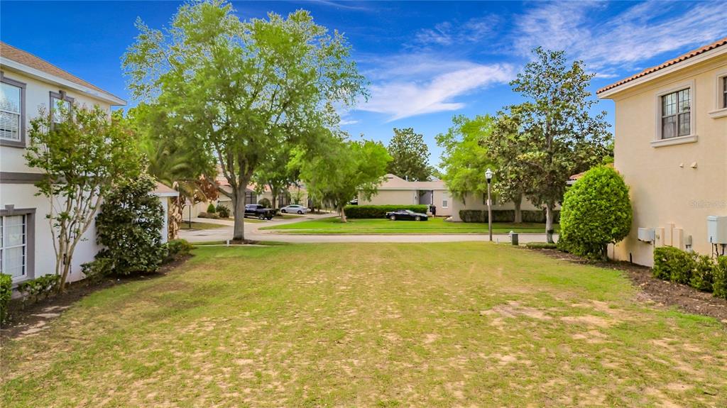 1233 Radiant Street Reunion, FL 34747 - Photo 6 of 18 a view of yard with swimming pool and trees