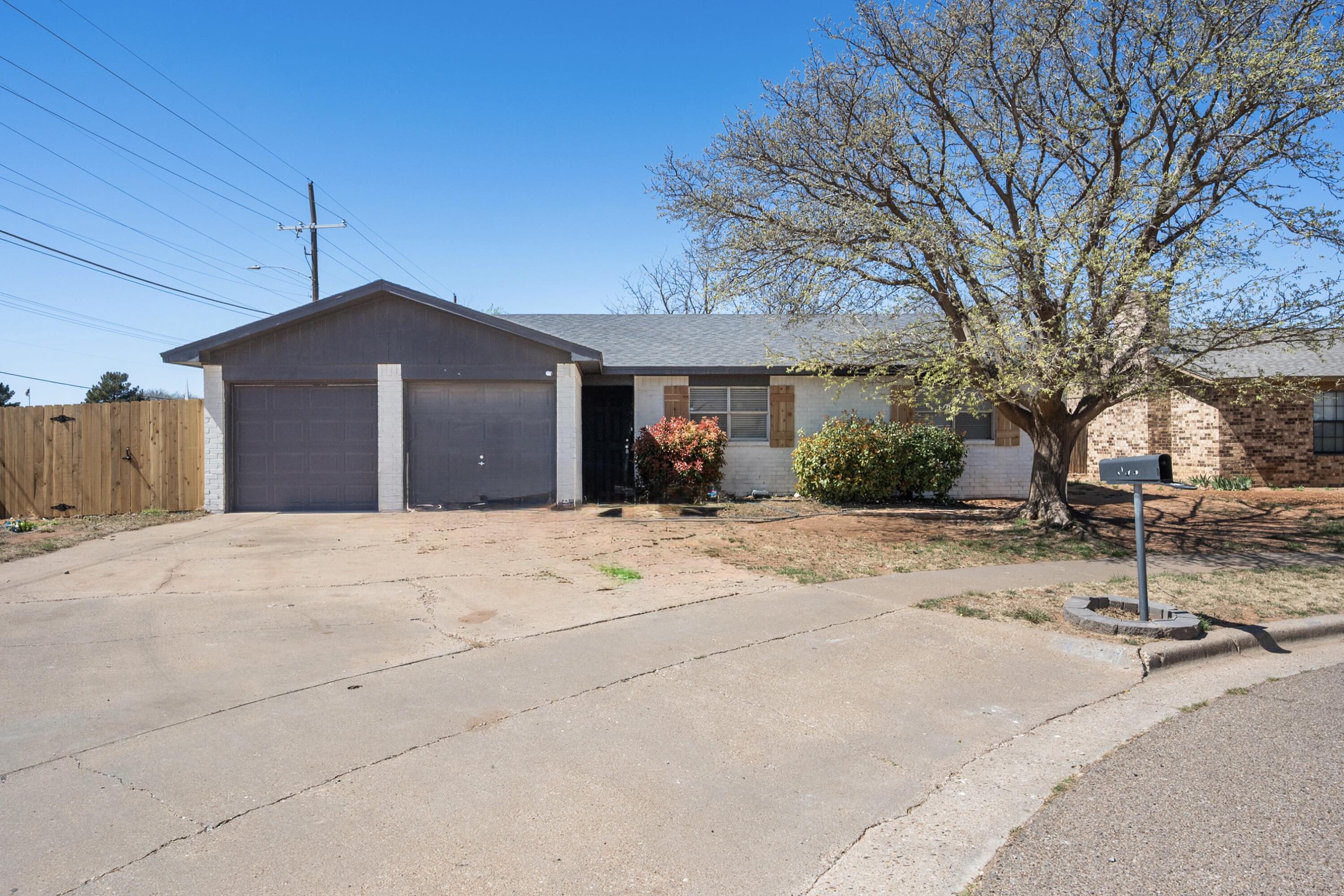 8110 Uvalde Avenue Lubbock, TX 79423 - Photo 1 of 11 a front view of a house with a yard