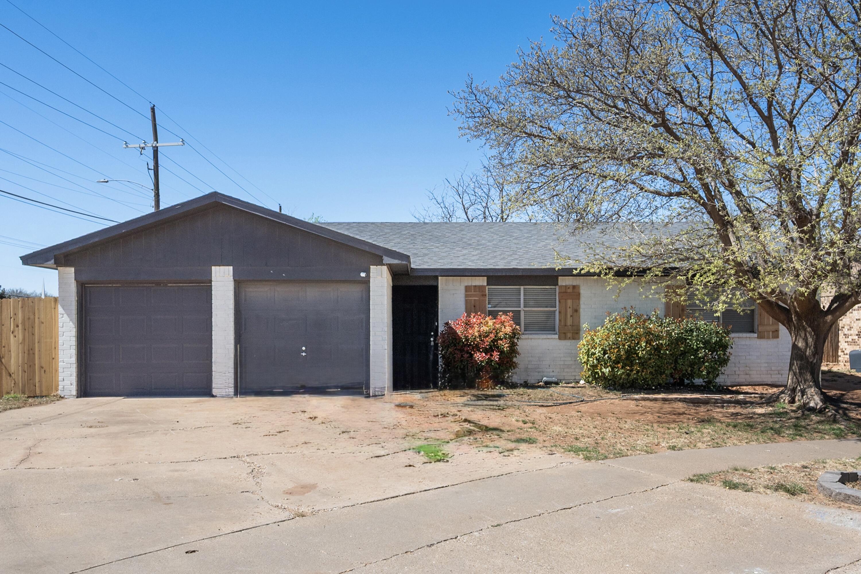 8110 Uvalde Avenue Lubbock, TX 79423 - Photo 2 of 11 a front view of a house with a yard