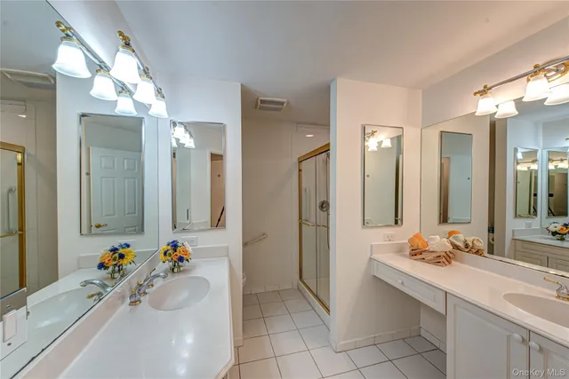 a bathroom with a tub sink and mirror