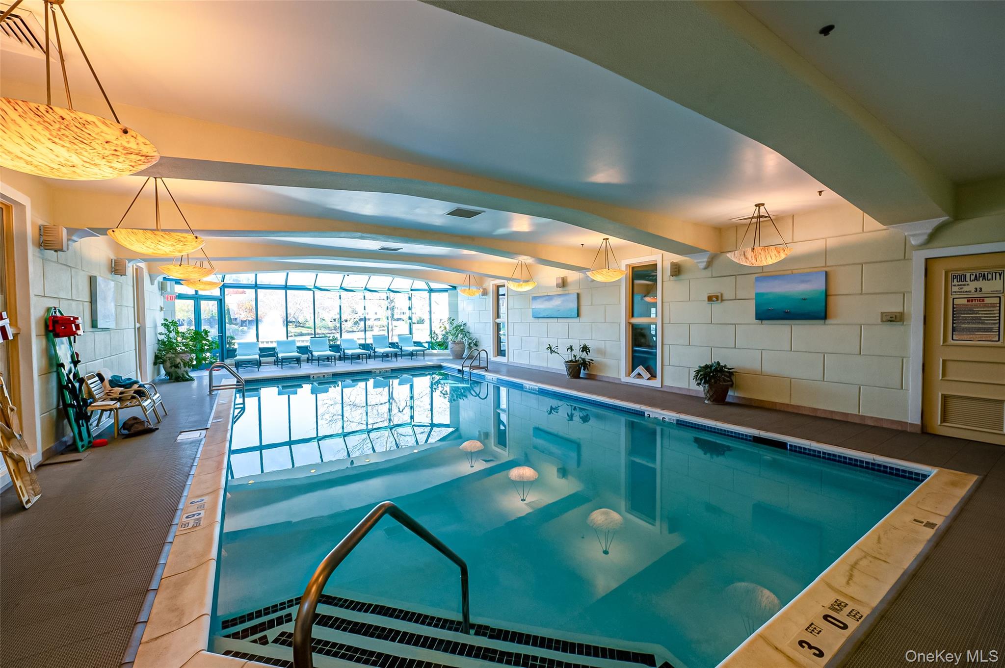 93 Carriage Lane, Unit AVON LOWER Plainview, NY 11803 - Photo 32 of 36 a view of a swimming pool with a patio